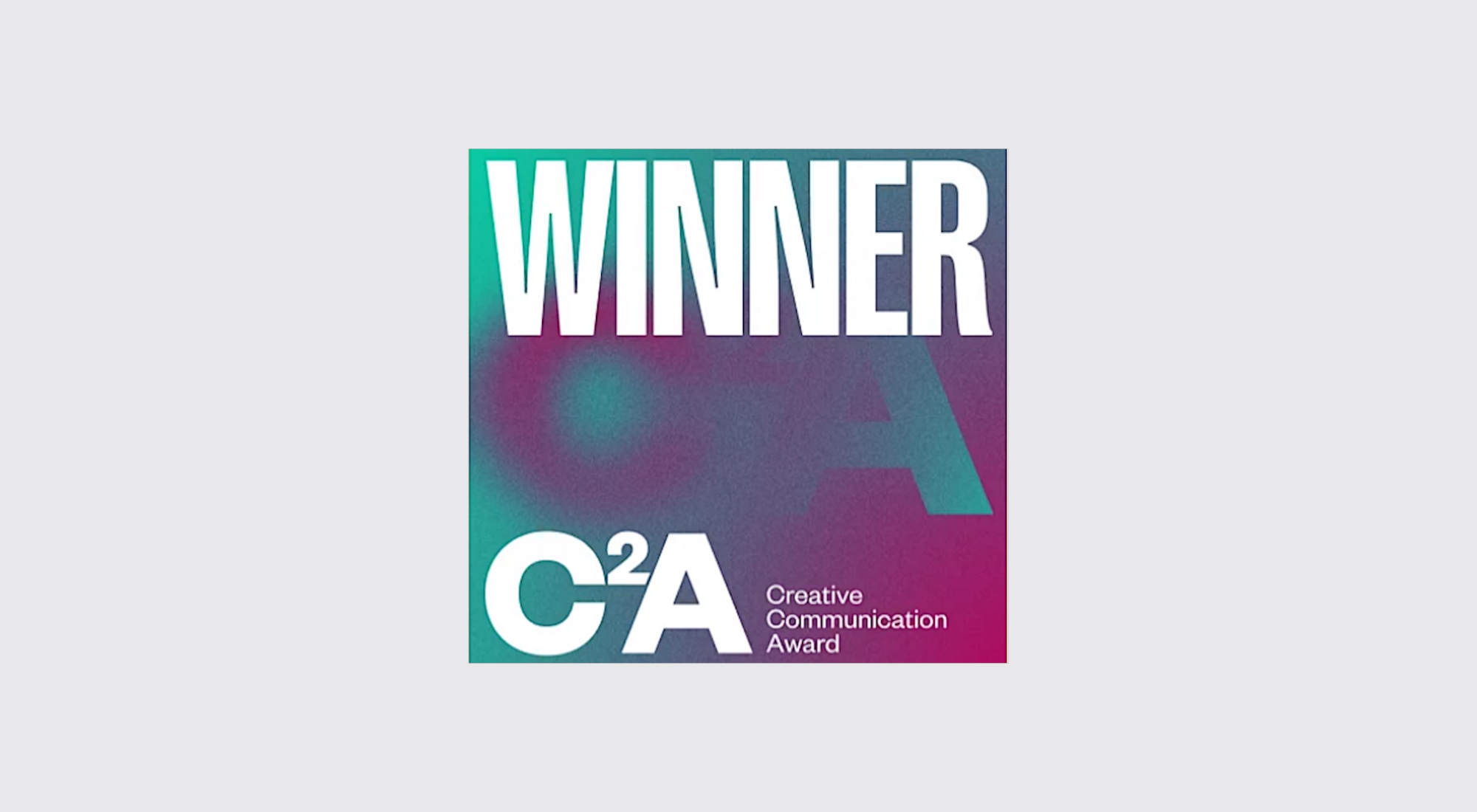 The Creative Communication Award Winner badge, with the word Winner above the C2A logo on a green and magenta gradient